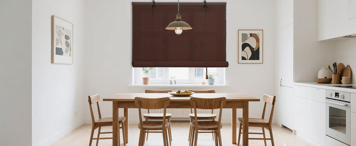 Dark brown bamboo roll-up window shade over dining room window with cord pull.