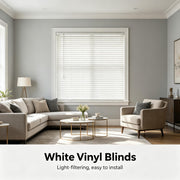 White PVC mini blinds closed on a window, horizontal slats